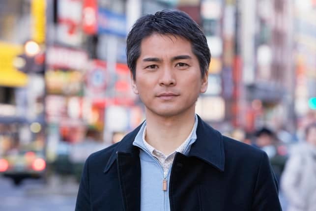 a portrait of a serious asian man