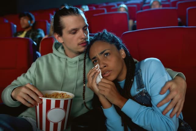 a couple watching a sad movie together