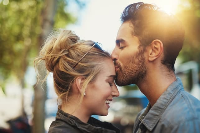 a couple kissing in a library