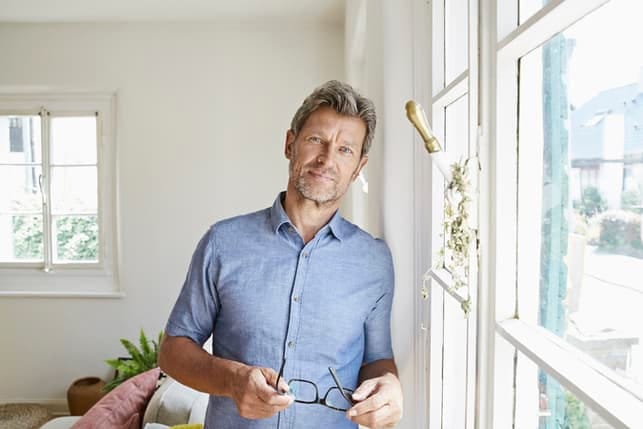 a portrait of a mature man in a blue shirt