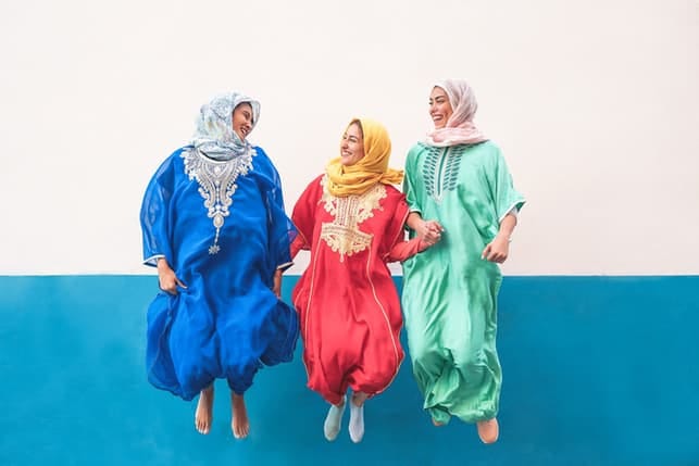 three women in traditional costumes laughing