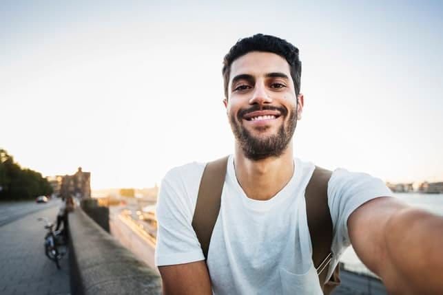 a young Arab man taking a selfie