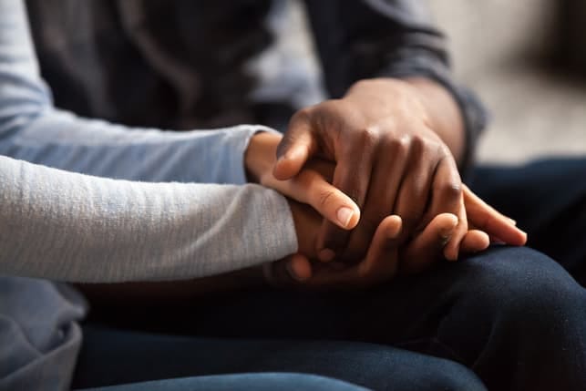 a couple holding each others’ hands