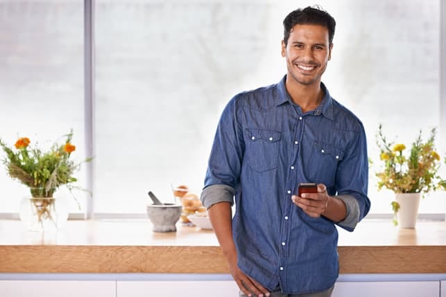 a handsome man in a blue shirt posing