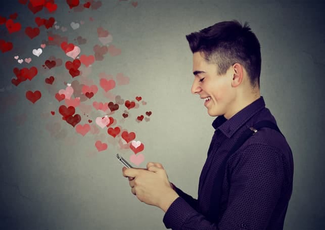 a young man is enjoying online dating via his smartphone