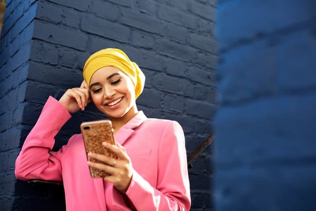 a young beautiful woman in traditional clothing checking her phone