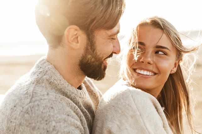 a young happy couple looking into each others eyes