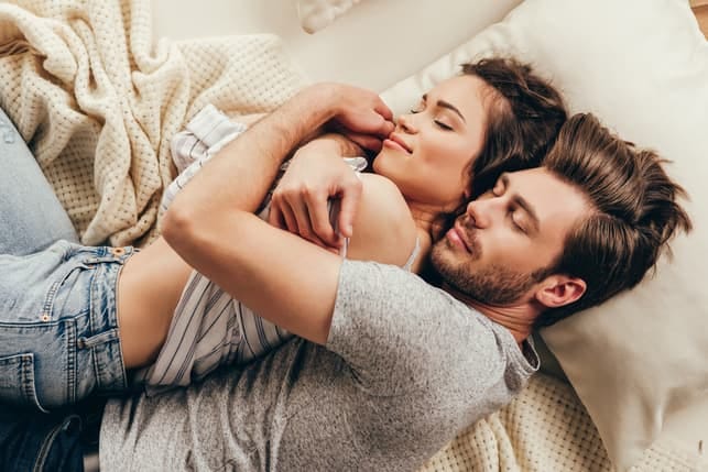 a couple hugging and sleeping together