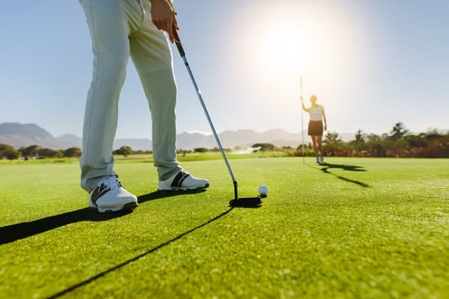a couple playing golf together