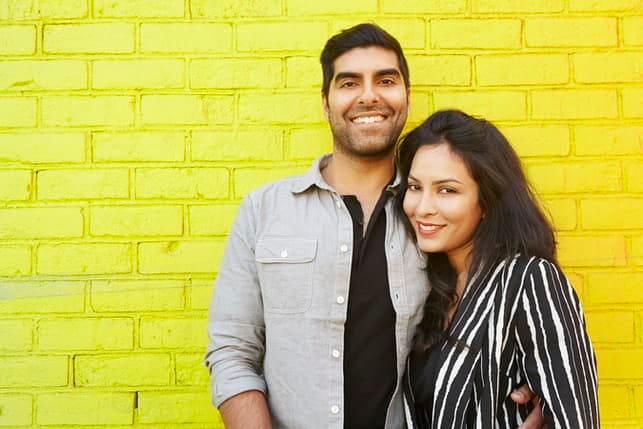 a southern adult couple is smiling and posing together