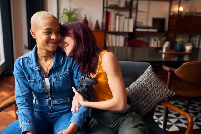 a lesbian couple playing video games together