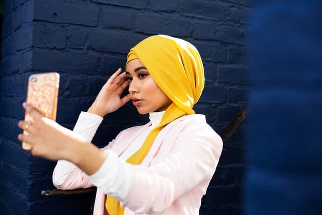 a charming arab girl taking a selfie with her phone