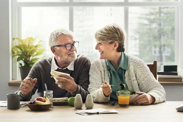 a senior couple having dinner together