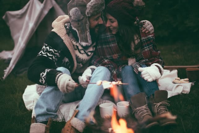 a couple is having a cosy camping date in autumn