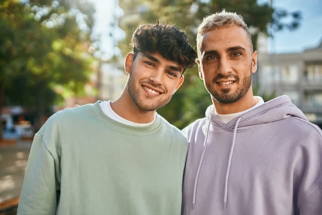 a gay couple posing casually outdoors