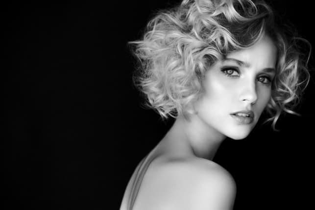 a black-and-white portrait of a blonde curly woman