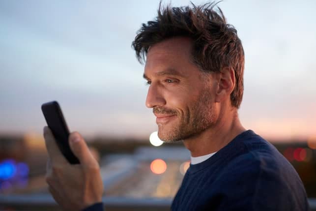 a portrait of a man using his smartphone