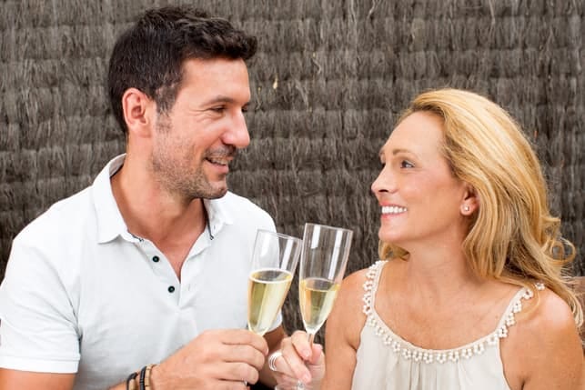 a mature couple drinking wine and having fun together