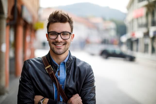 a portrait of a young man in glasses