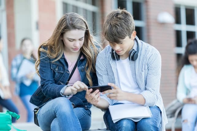 a young couple watching videos on a smartphone together