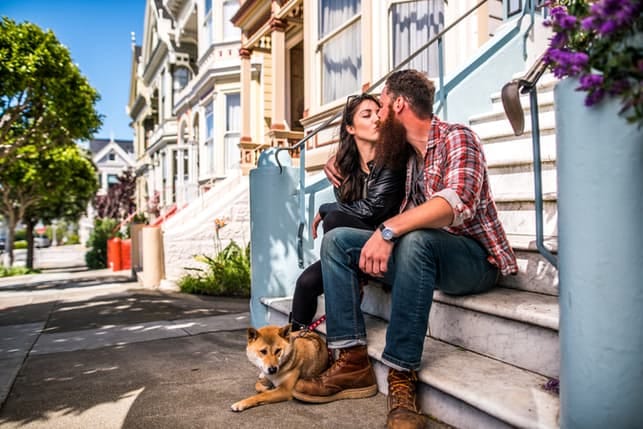 a couple is kissing outdoors in the town