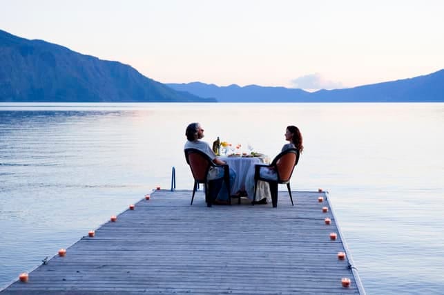 sweet couple having a dinner with the view on the lake