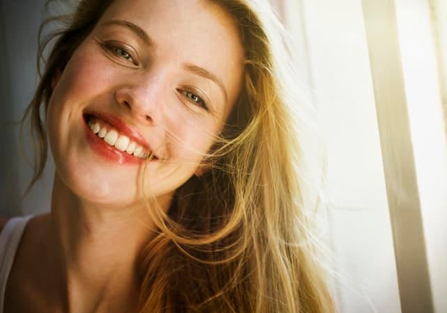 a portrait of a young blonde girl smiling